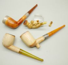 Four carved Meerschaum pipes, cased