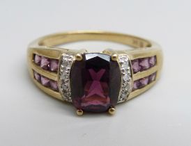 A 9ct gold, diamond and garnet ring, 4.3g, S