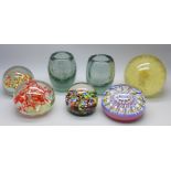 Four glass paperweights, two glass vases, and a resin paperweight