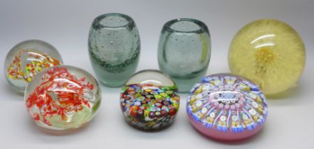 Four glass paperweights, two glass vases, and a resin paperweight