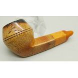 An early 20th Century Meerschaum pipe, missing end of amber stem, carved with fifty-two different