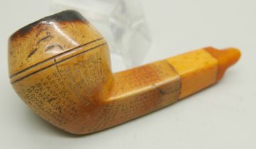 An early 20th Century Meerschaum pipe, missing end of amber stem, carved with fifty-two different