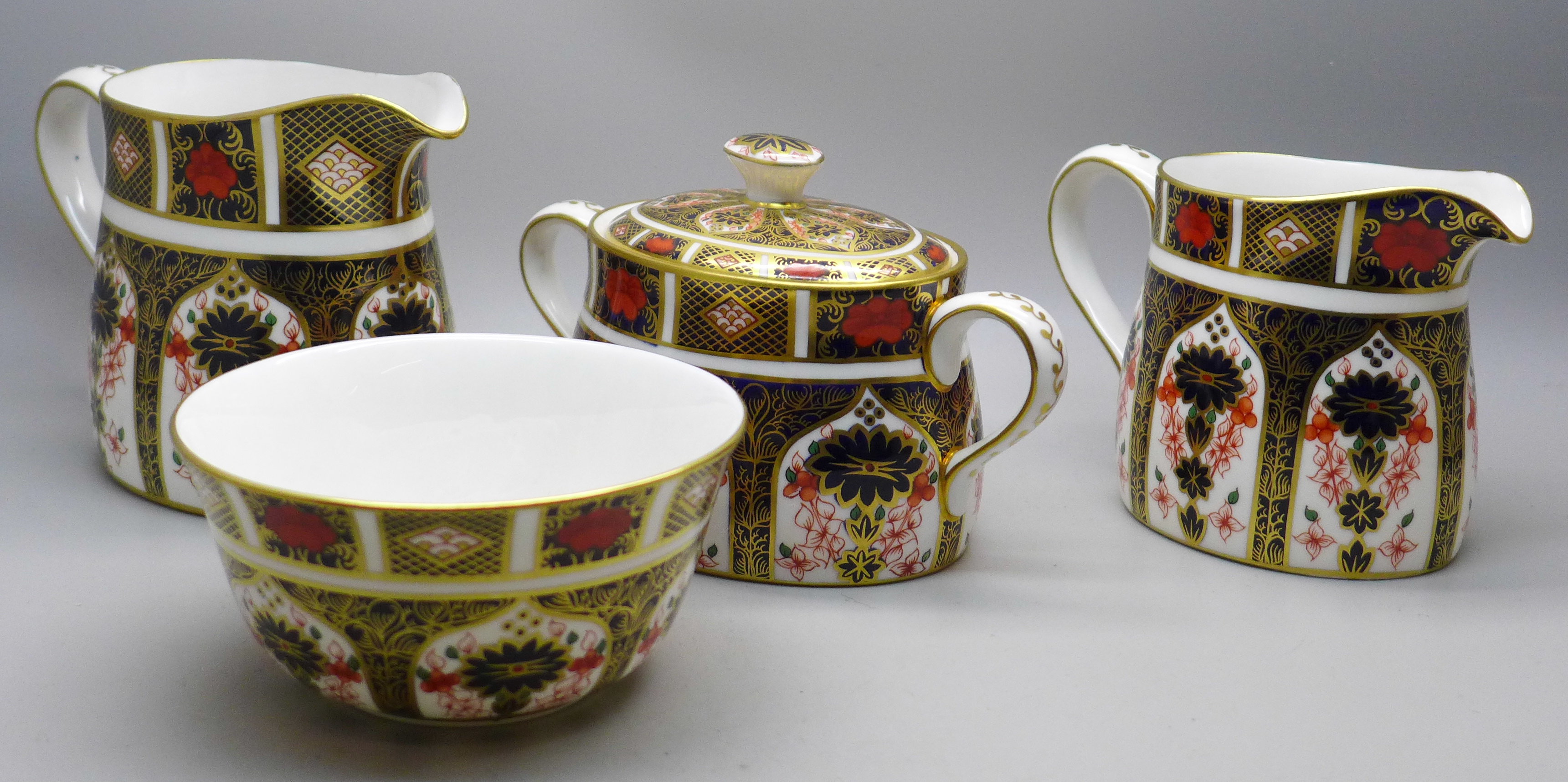 A Royal Crown Derby 1128 Imari pattern cream jug and sugar (x2), smaller milk jug second