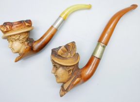 A carved Meerschaum pipe of a Victorian lady, amber stem, cased and one other loose