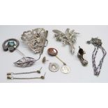 A silver brooch, a silver chain, etc.