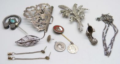 A silver brooch, a silver chain, etc.