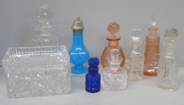 A collection of scent bottles and a glass cigarette box