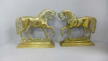 A pair of brass horse fire dogs/door stops