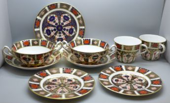 A collection of Royal Crown Derby 1128 pattern Imari; two tea plates, three large saucers, two