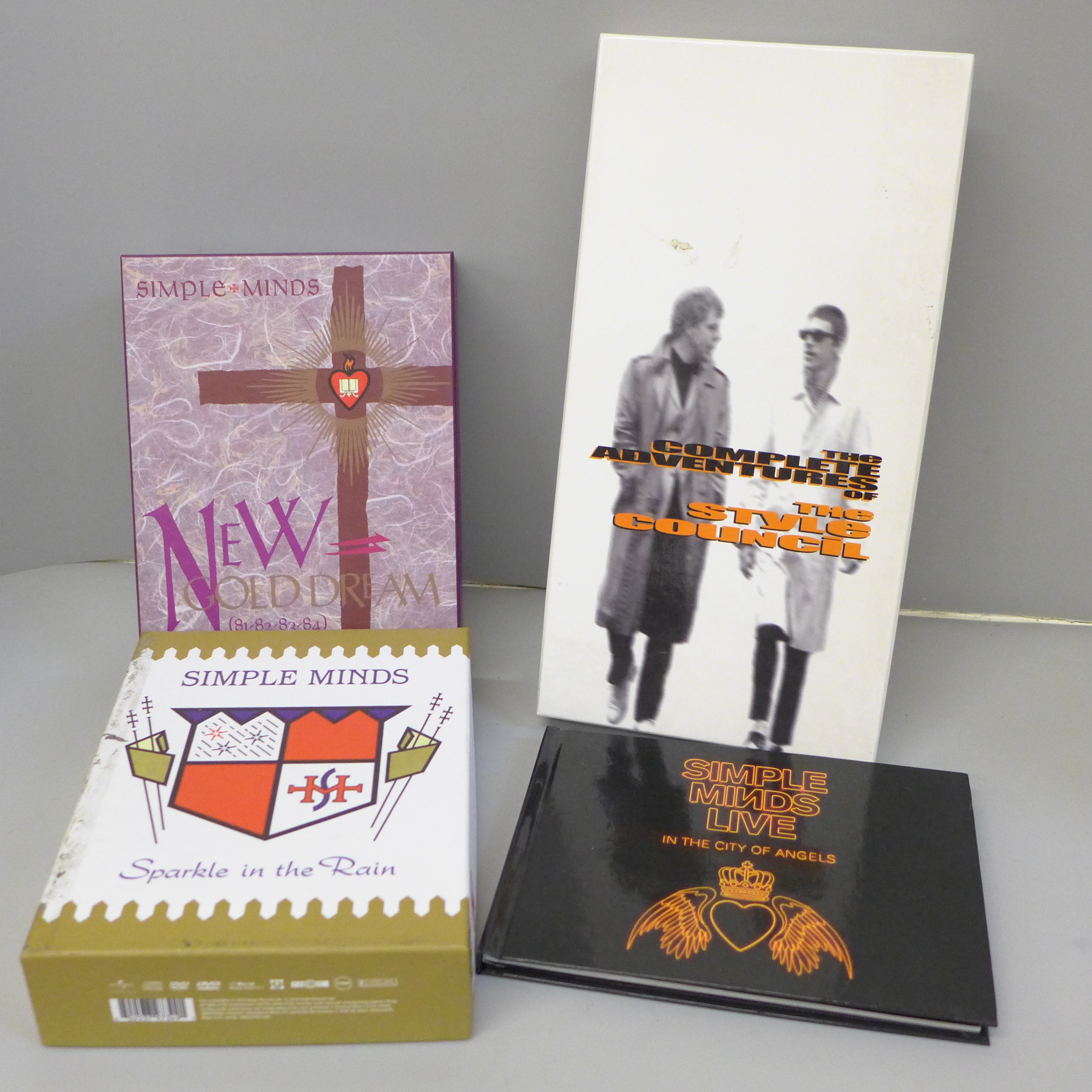 Two Simple Minds DVD box sets, Sparkle In The Rain and New Gold Dream and booklet, In The City of