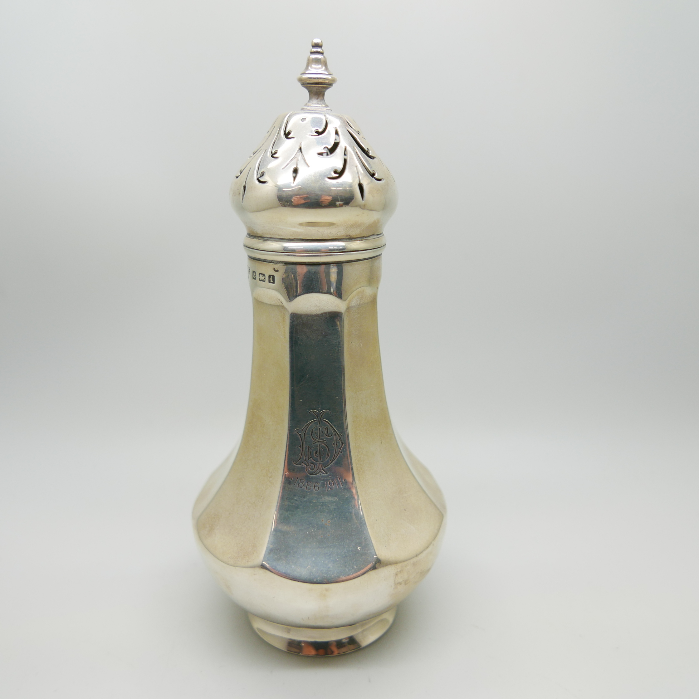 A silver shaker, Birmingham 1910, 166g, bears initials