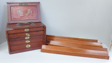 A Mahjong set in original wooden box, bone and bamboo pieces with documents from the Sungei Ljong