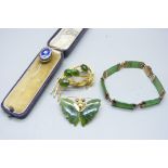 A silver set jade bracelet, two jade set brooches and an enamelled pin