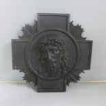 A bronze religious plaque in relief of Jesus Christ wearing a crown of thorns, signed M. Thomas