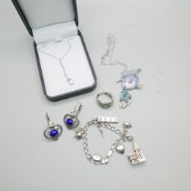 Silver jewellery; a pendant and chain x2, earrings, ring and charm bracelet
