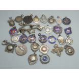 Twenty-three silver fob medals, some enamelled, 214g, four other fob medals and a charm bracelet