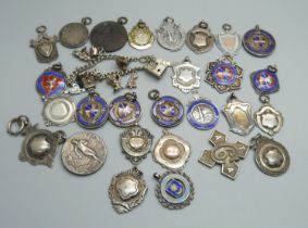 Twenty-three silver fob medals, some enamelled, 214g, four other fob medals and a charm bracelet