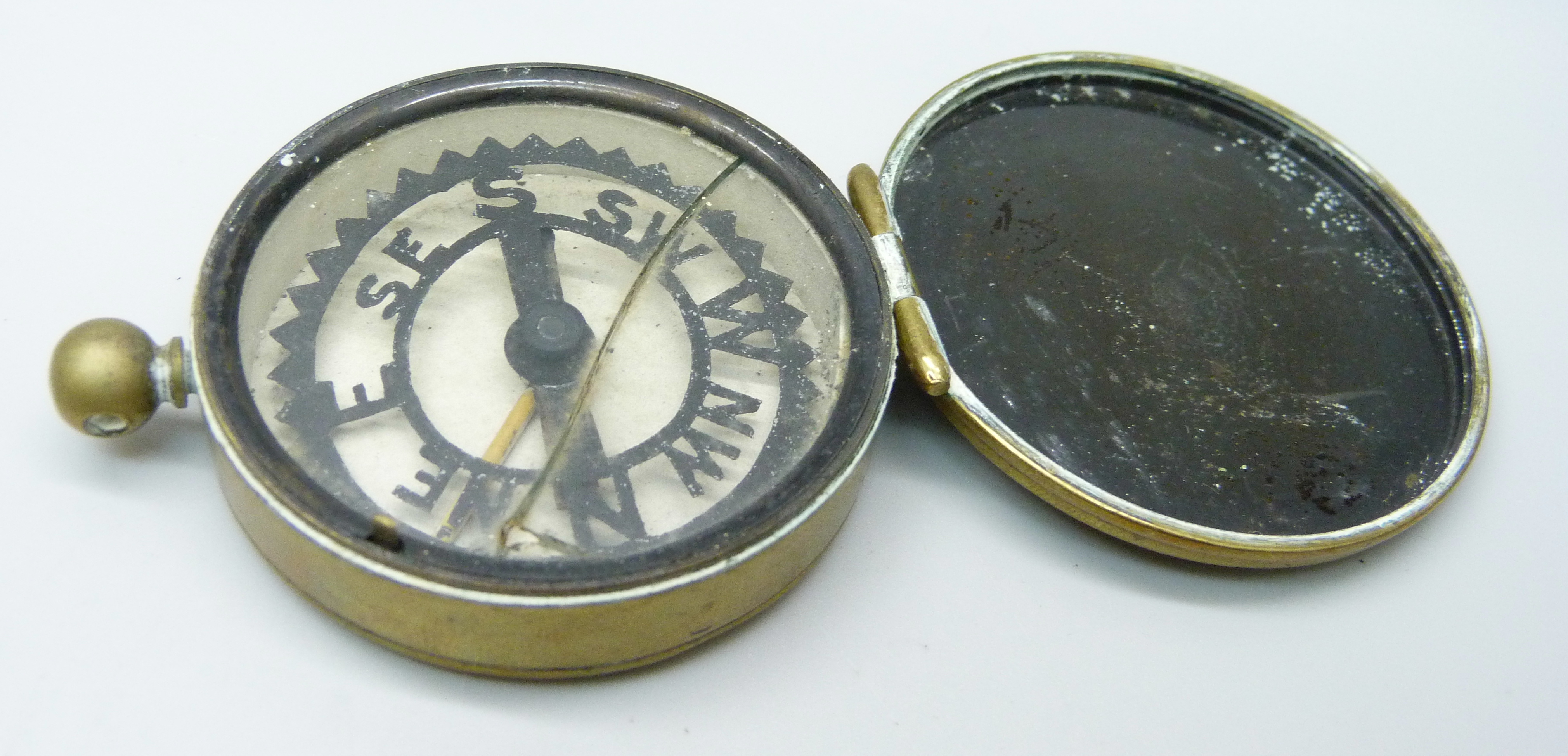 A pocket compass by Negretti & Zambra, with inscription, ''Trooper E.O. Robotham, I.Y. Jan. 10th