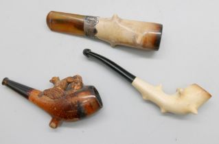 Three carved Meerschaum pipes, cased