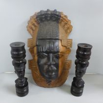 Tribal art; large wall mounted teak carved face mask (37cm tall) and a pair of hardwood turned