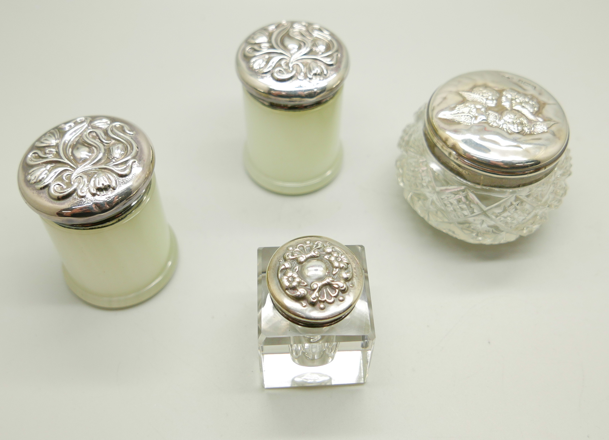 A pair of silver topped pots, a silver topped jar and an inkwell