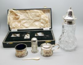 A silver condiment set, cased, and a silver topped shaker, 80g