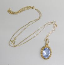 A 14ct rolled gold and topaz pendant on a fine 9ct gold chain, chain 45cm