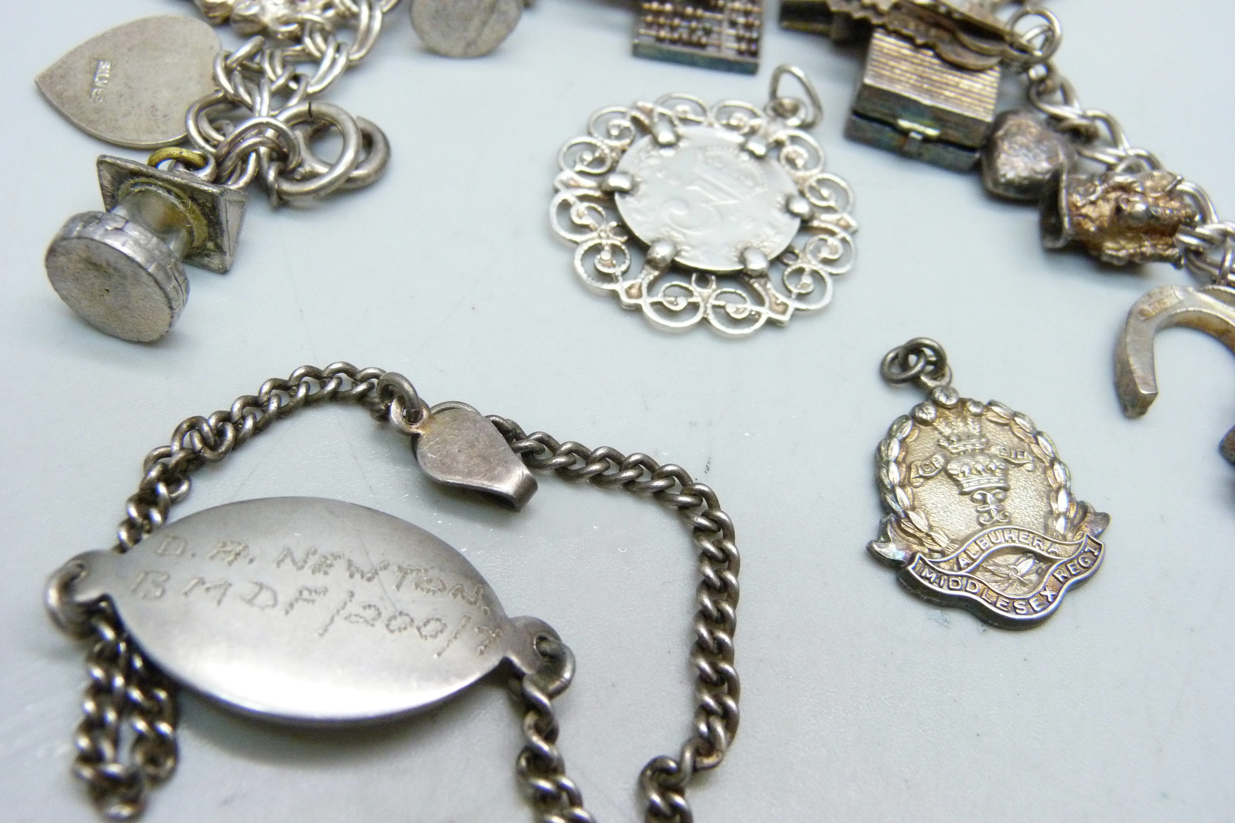A silver charm bracelet, two silver pendants and a bracelet, 68g - Image 3 of 4
