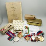 A WWI Christmas tin, WWII medals, etc.