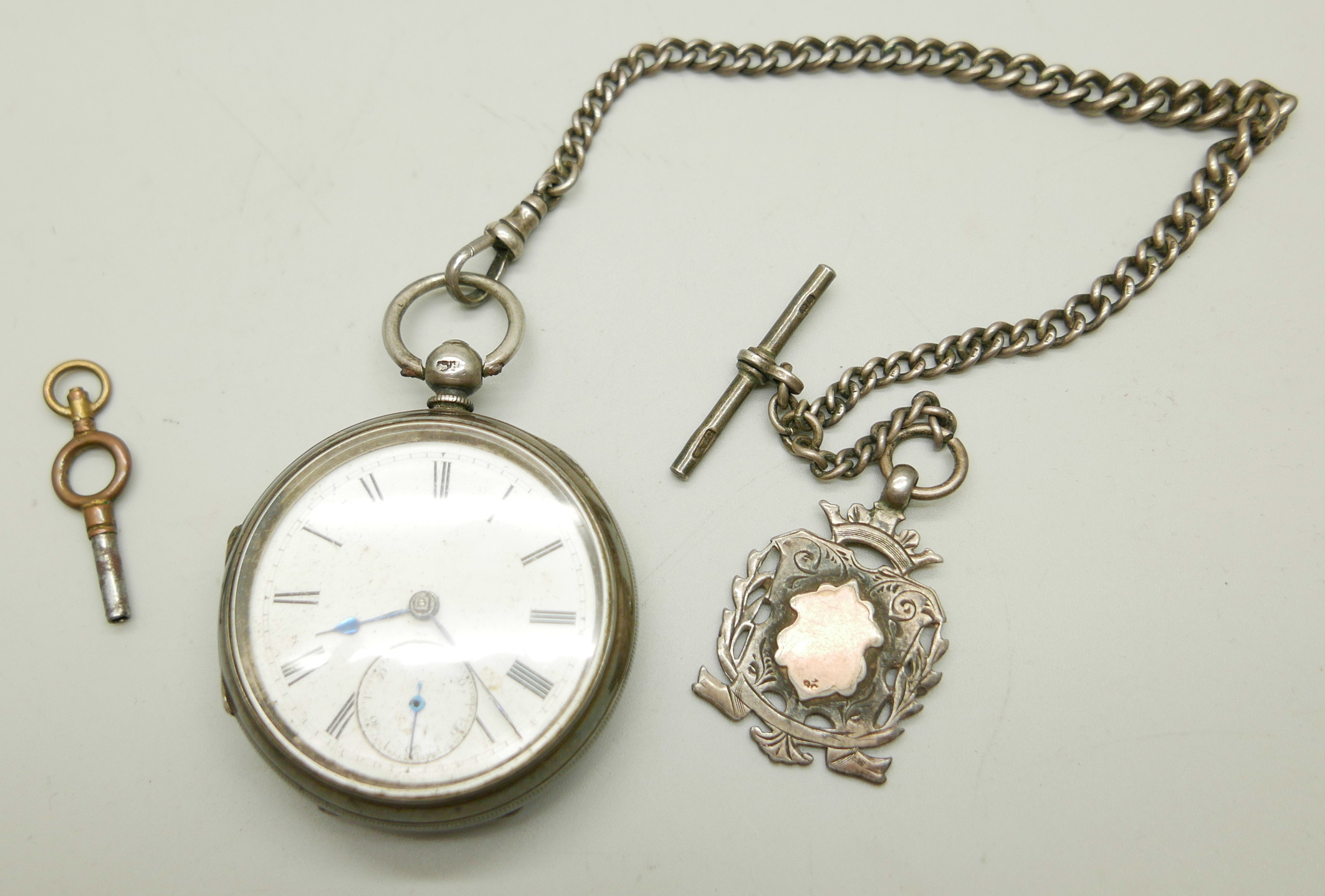A silver pocket watch, a silver Albert chain, fob and key, boxed