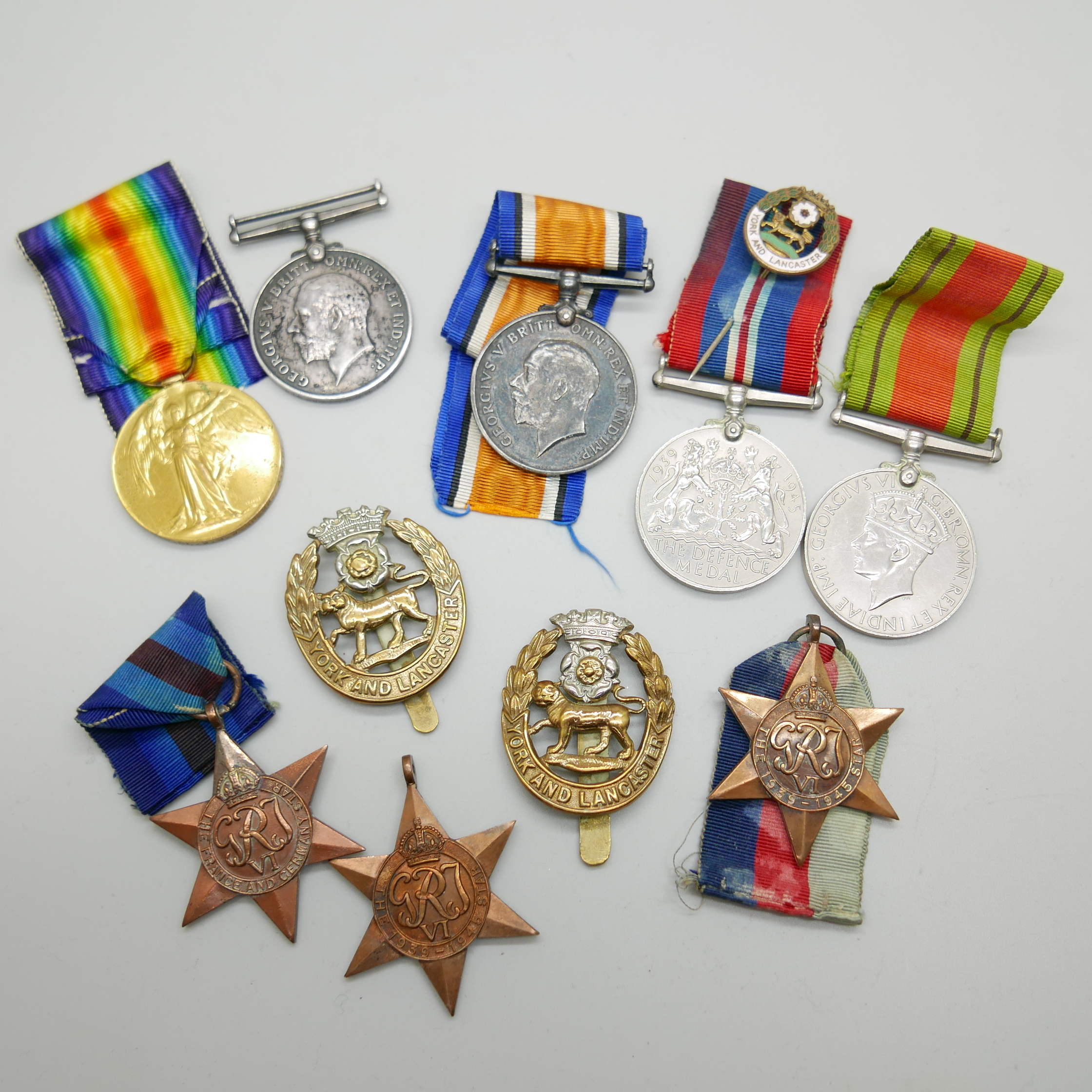 Eight medals and two badges; including a pair of WWI medals to S4-143747 W.O. CL. 2. J.W. Speck