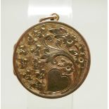 A yellow metal circular engraved locket, 23mm