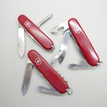 Three Victorinox Swiss multi-tool knives