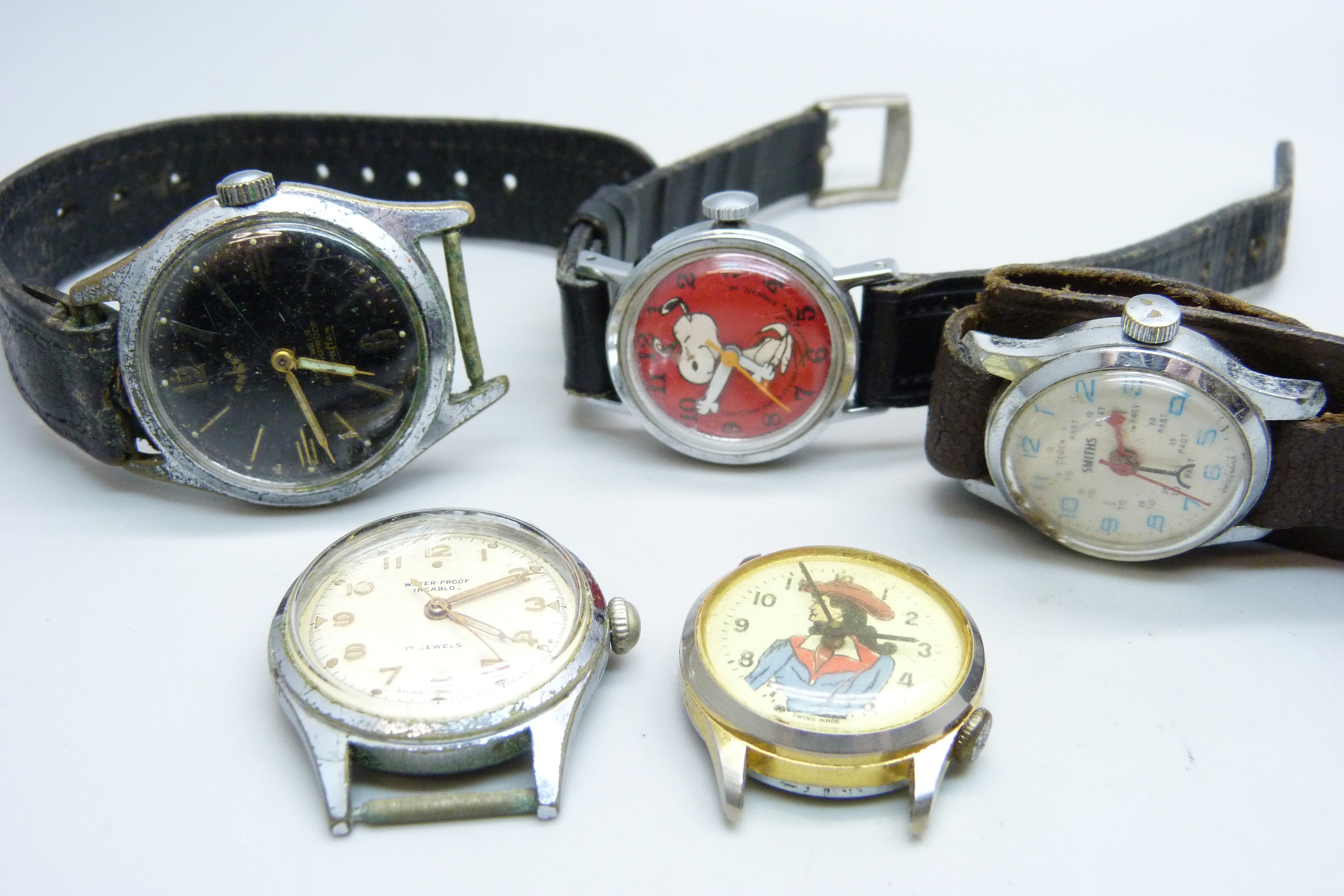 Five wristwatches including Snoopy