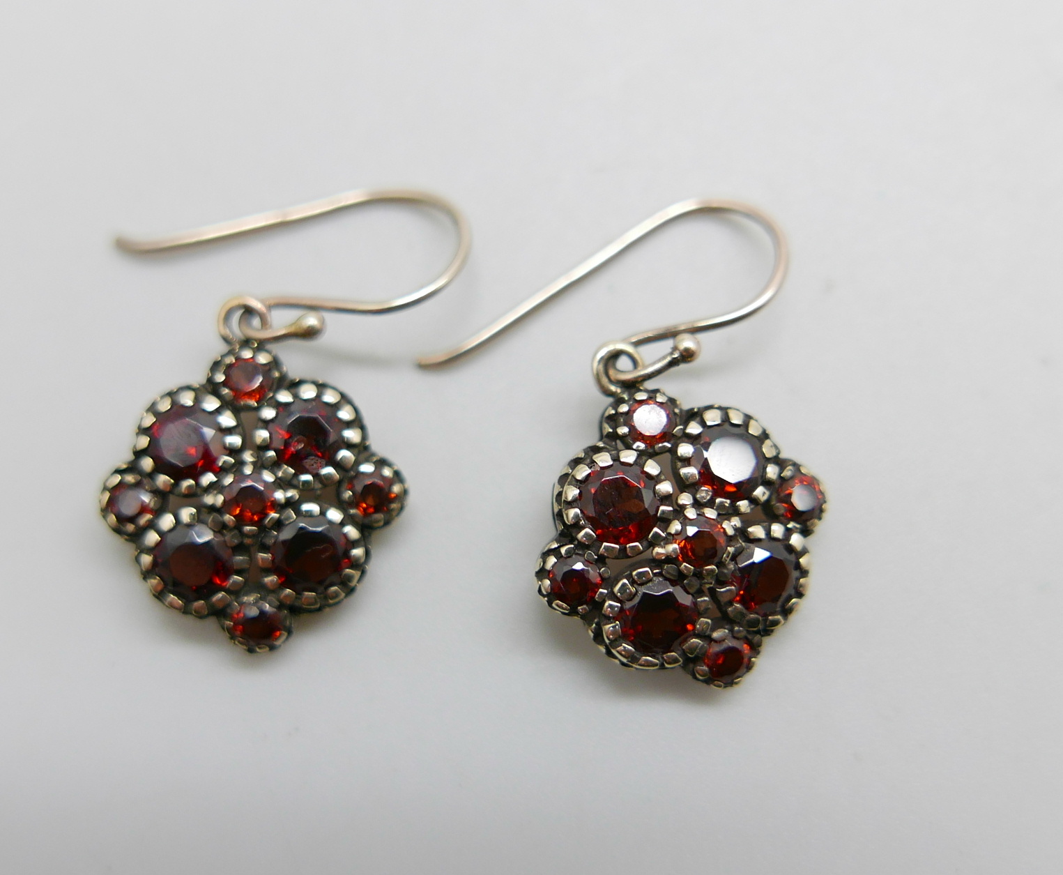 A pair of hallmarked 9ct gold and garnet set earrings, 3.7g