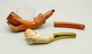 Two hand carved Meerschaum pipes in the form of a lady's hand in glove, the larger pipe with