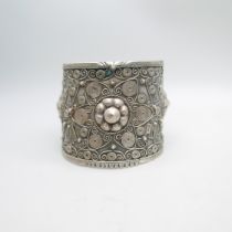 An ornate wide silver bangle, marked 84 and 800, 62g