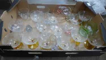 A collection of glass including six coloured shot glasses, six clear champagne coupes, seven