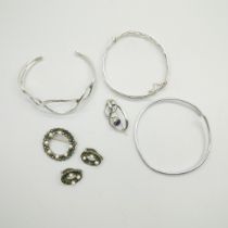 A silver Charles Horner brooch, three silver bangles, one set with two small diamonds, and a silver,