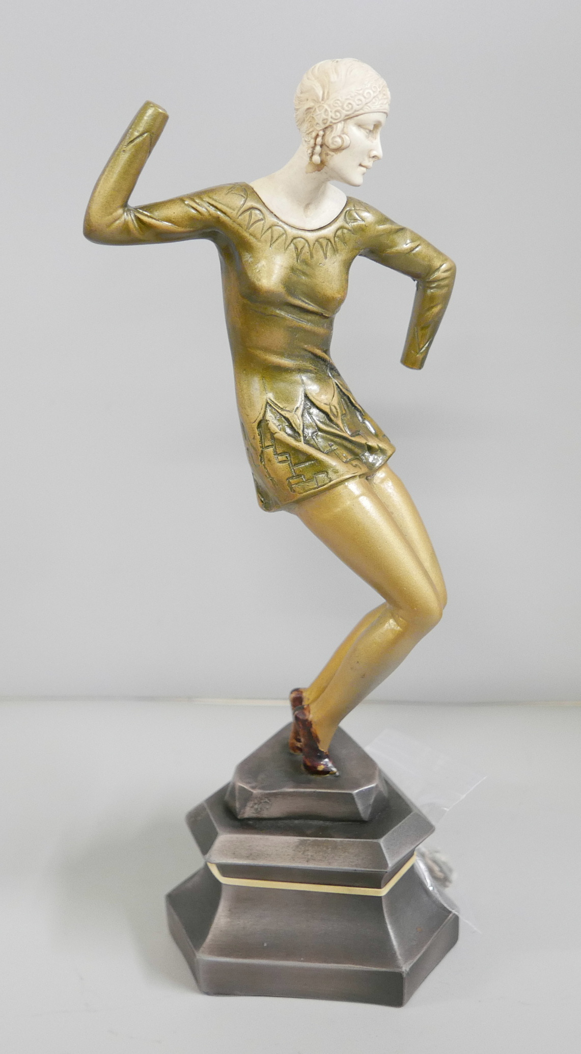 An Art Deco style figure of a dancer, after Chiparus, a/f, hands with figure, requires