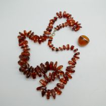 An amber necklace and a ring size M