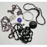 Two jet necklaces and brooch, two garnet necklaces, one a/f, three silver brooches, one white