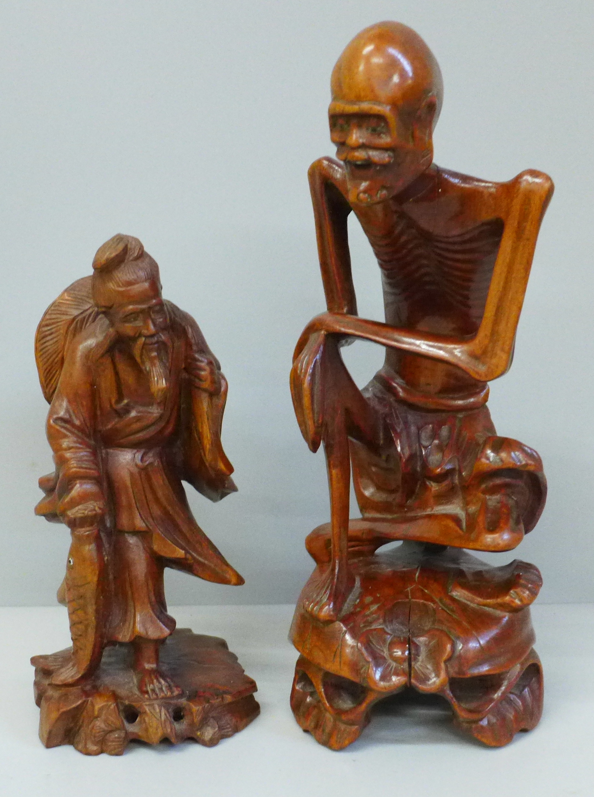 Two carved wooden oriental figures, tallest 21cm, smaller figure with chip to side