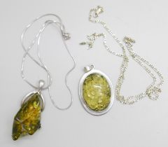 Two silver and green amber pendants and chains
