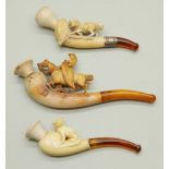 Three carved Meerschaum pipes, cased