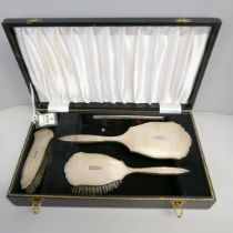 A silver vanity set, cased