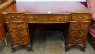 A Chippendale style mahogany and red leather topped library desk