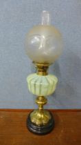 A Victorian brass oil lamp, with Vaseline glass reservoir