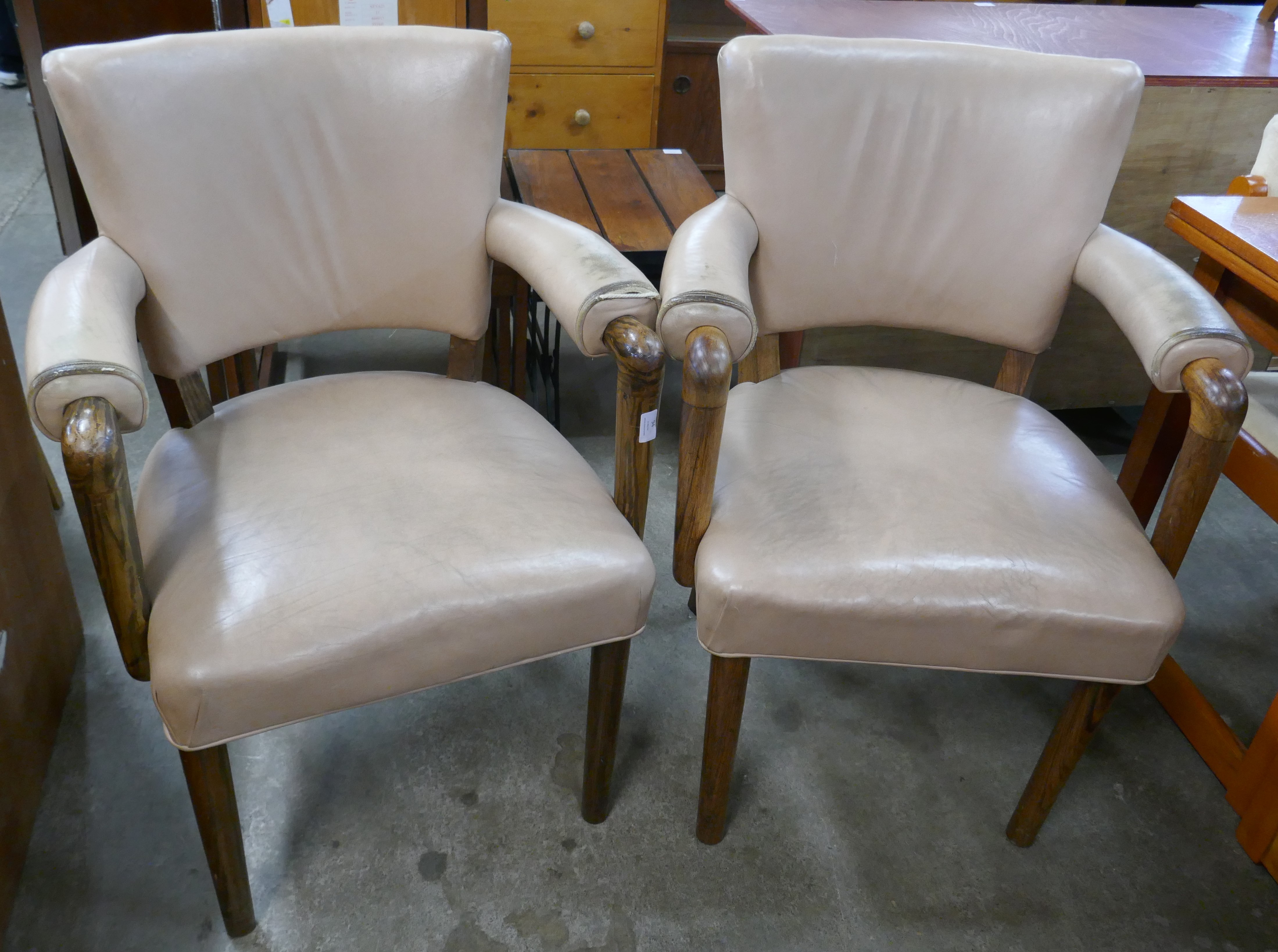 A pair of Laszlo Hoenig hardwood and leather elbow chairs