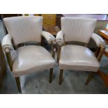 A pair of Laszlo Hoenig hardwood and leather elbow chairs